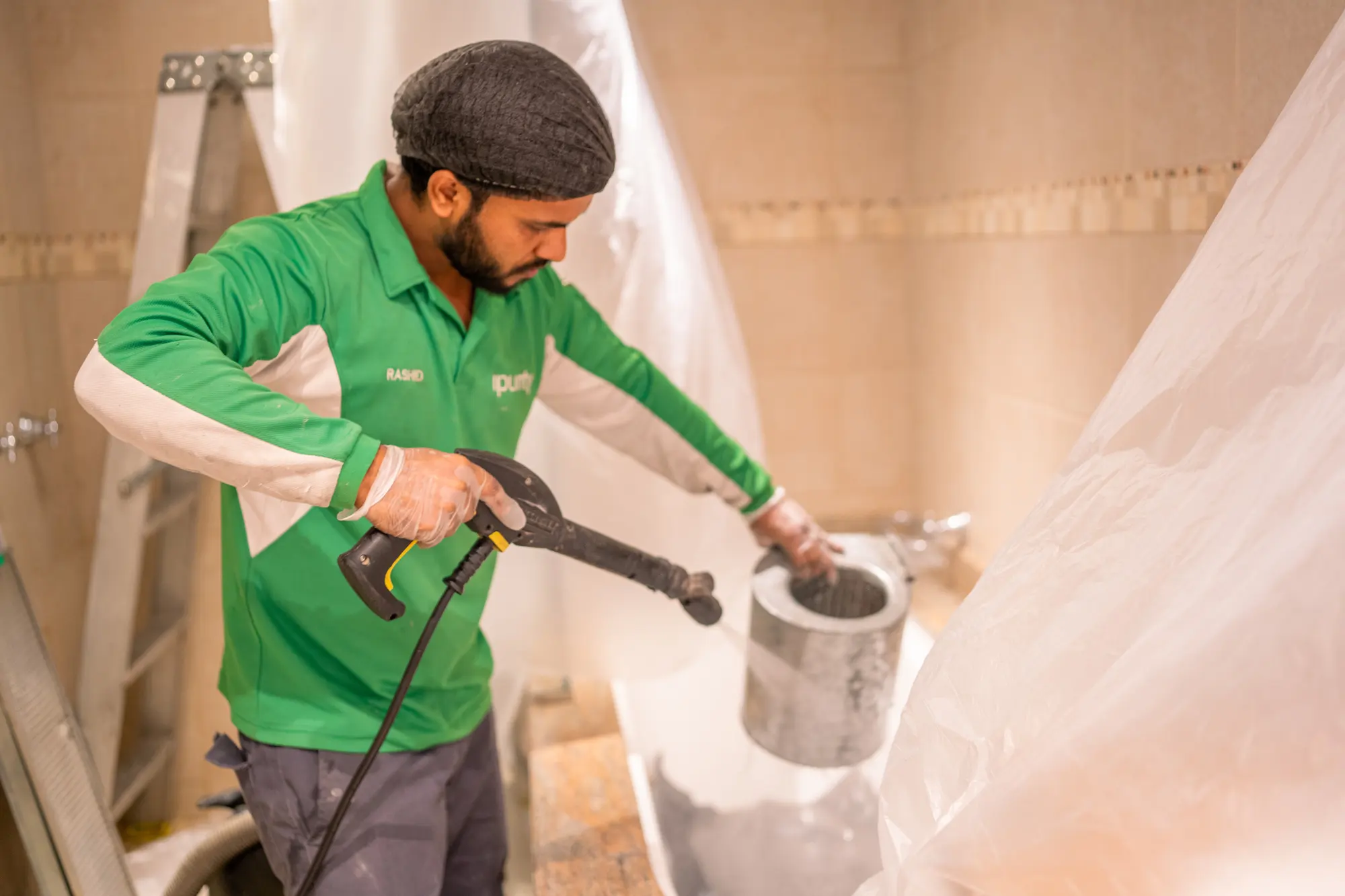 Technician washing a component