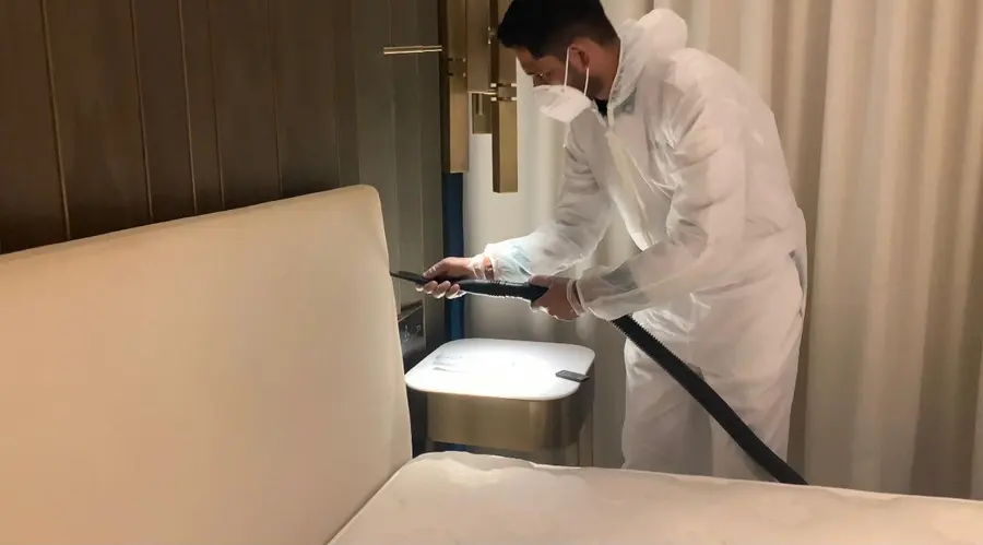 An iPurity technician steam-treating an upholstered headboard
