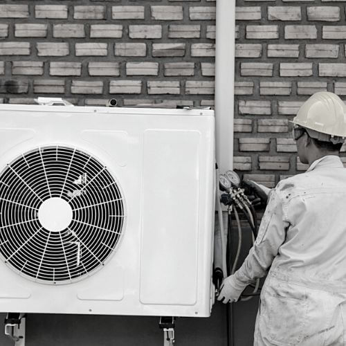  a man repairing ac in dubai